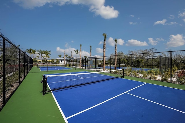 view of tennis court with basketball hoop