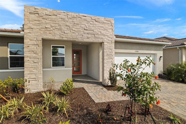 view of exterior entry featuring a garage