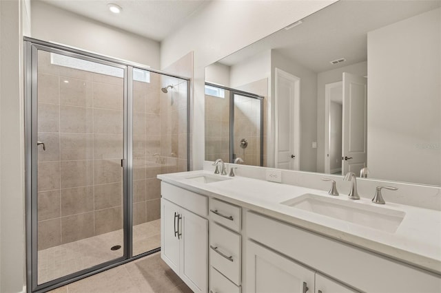 bathroom featuring vanity and a shower with shower door