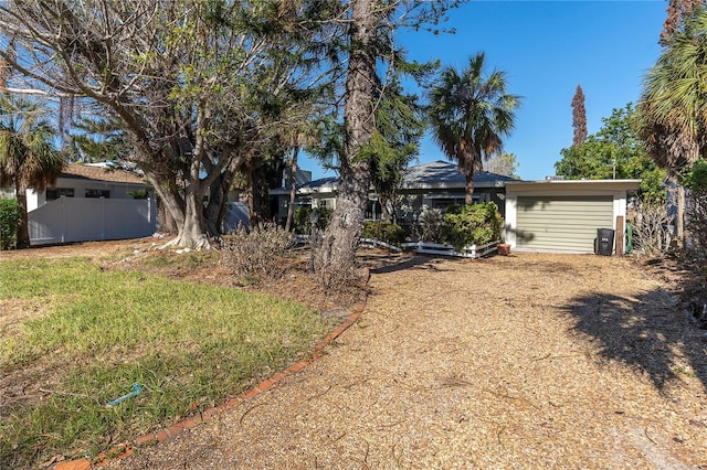 505 80th Ave, St Pete Beach, FL 33706 - view of yard featuring a garage and driveway