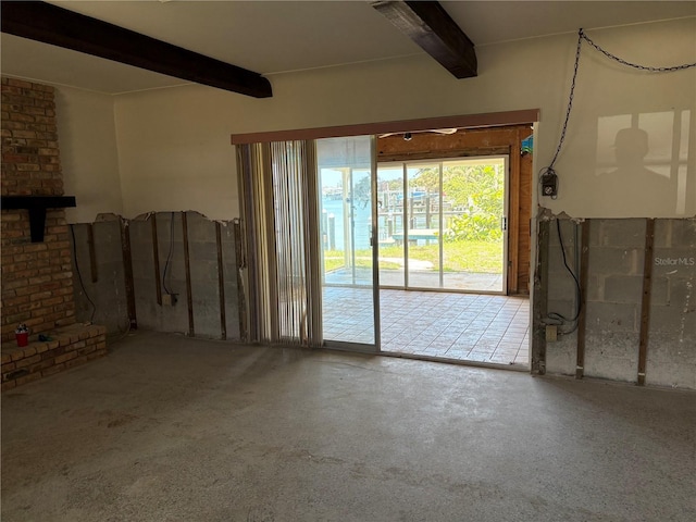 505 80th Ave, St Pete Beach, FL 33706 - unfurnished living room featuring beamed ceiling and concrete floors