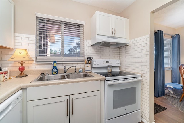 kitchen featuring dishwasher, white cabinets, sink, range with electric stovetop, and light wood-type flooring