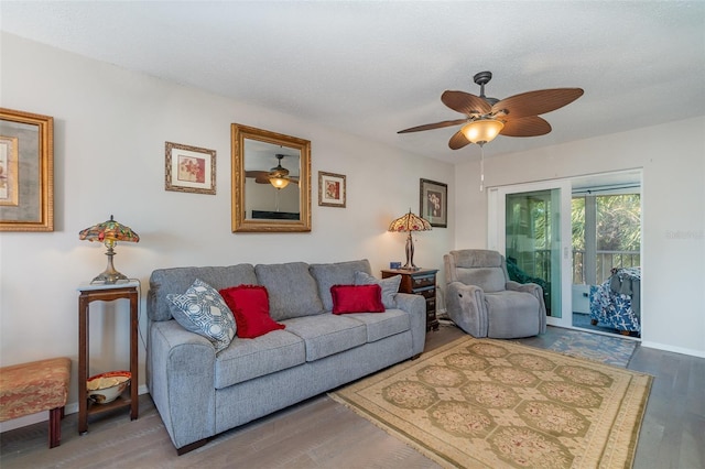 living room with wood-type flooring, a textured ceiling, and ceiling fan