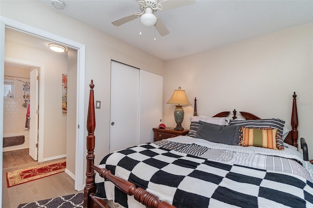 bedroom featuring hardwood / wood-style flooring, ceiling fan, a textured ceiling, and a closet