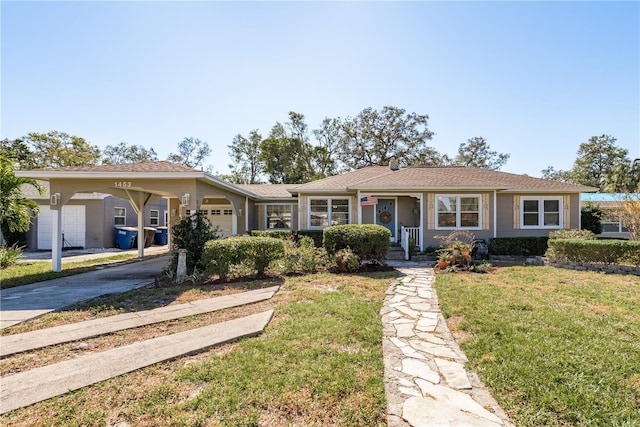 ranch-style home featuring a garage and a front lawn