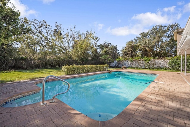 view of swimming pool featuring a yard and a patio