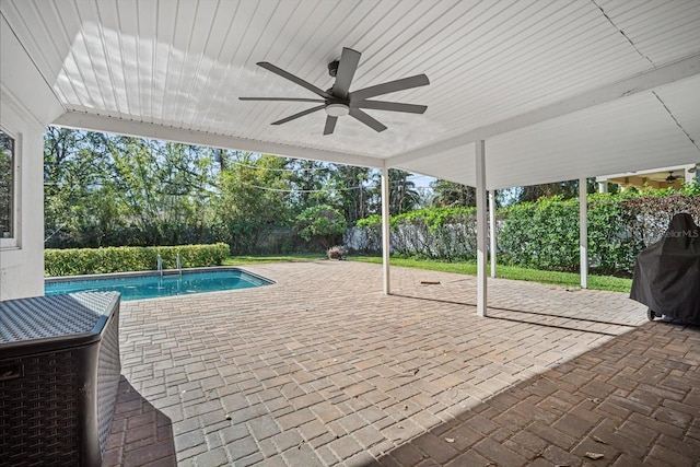 view of swimming pool with ceiling fan and a patio area