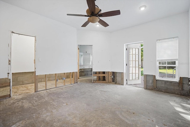 unfurnished living room with ceiling fan