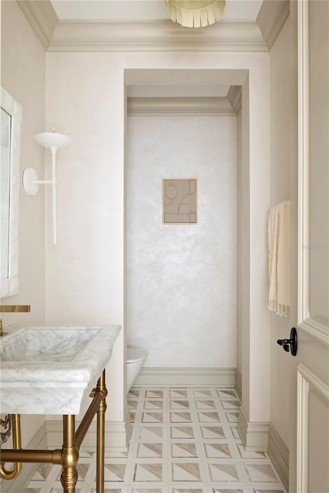 bathroom with toilet and ornamental molding