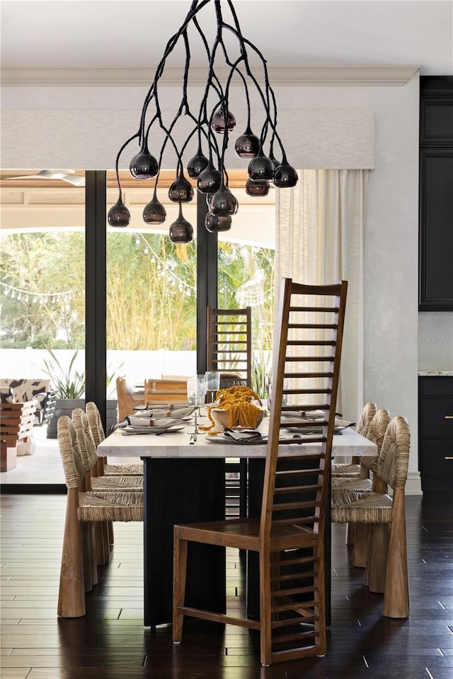 dining room featuring ornamental molding and dark wood-type flooring