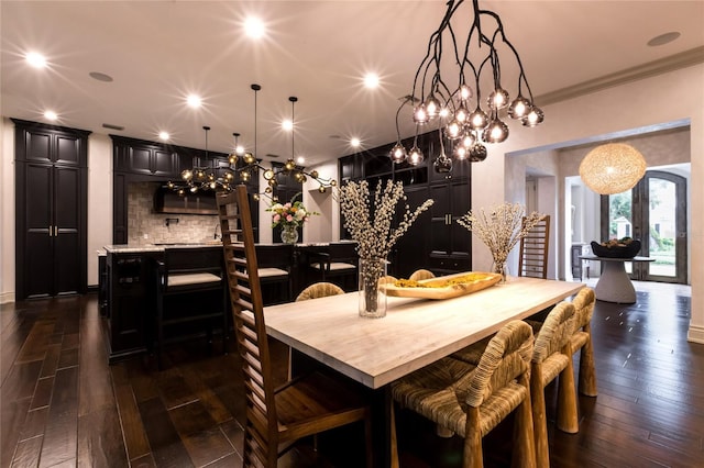 dining area featuring ornamental molding and dark wood-type flooring