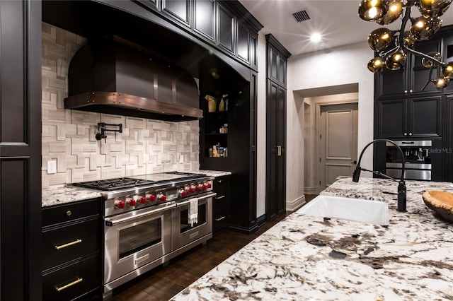 kitchen featuring sink, stainless steel appliances, dark hardwood / wood-style flooring, range hood, and backsplash