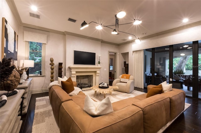 living room with a wealth of natural light, wood-type flooring, and ornamental molding