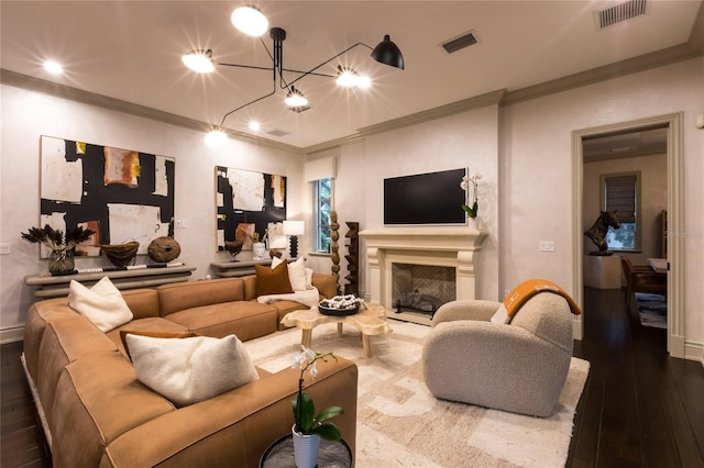 living room with dark hardwood / wood-style floors and ornamental molding