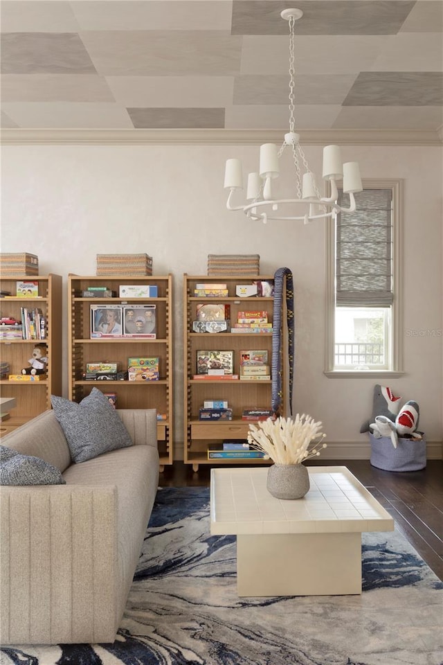 living room featuring dark hardwood / wood-style flooring, crown molding, and an inviting chandelier