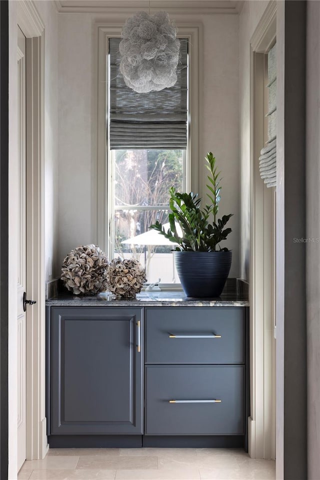 interior space featuring light tile patterned floors and gray cabinetry