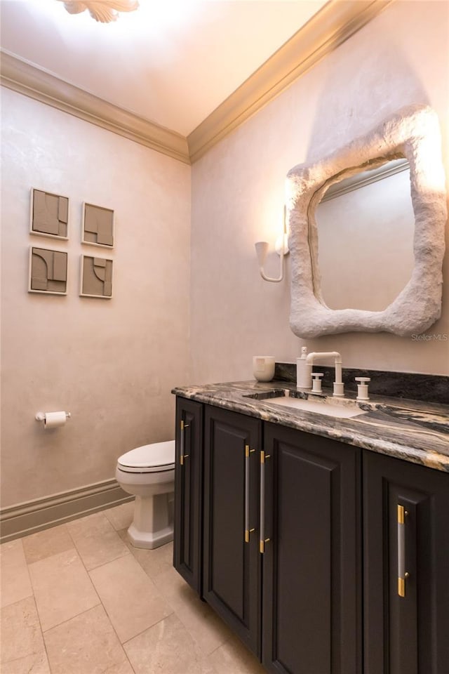 bathroom with vanity, toilet, and crown molding