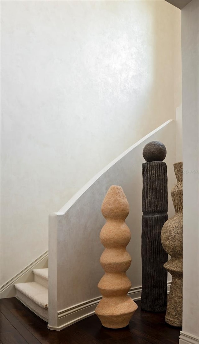 stairway with hardwood / wood-style flooring