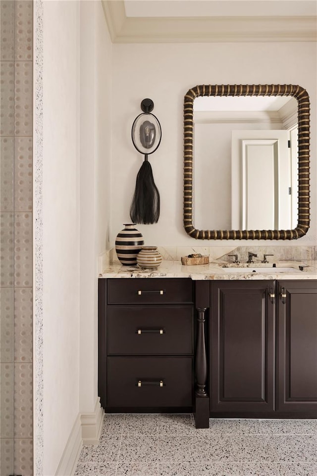 bathroom featuring decorative backsplash, crown molding, and vanity