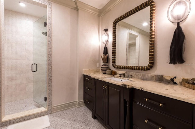 bathroom with vanity, an enclosed shower, and ornamental molding