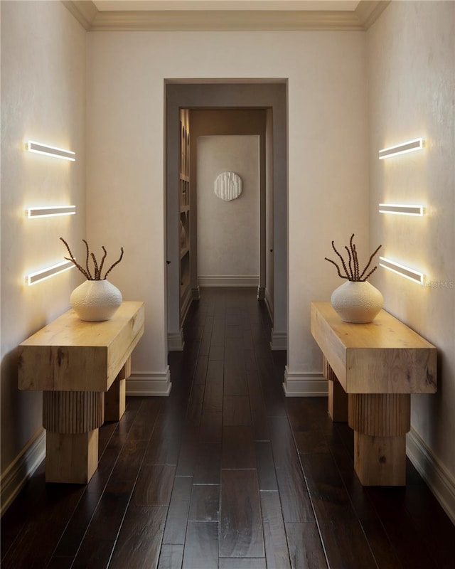 corridor with ornamental molding and dark wood-type flooring