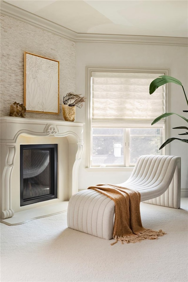 living area featuring carpet flooring and ornamental molding