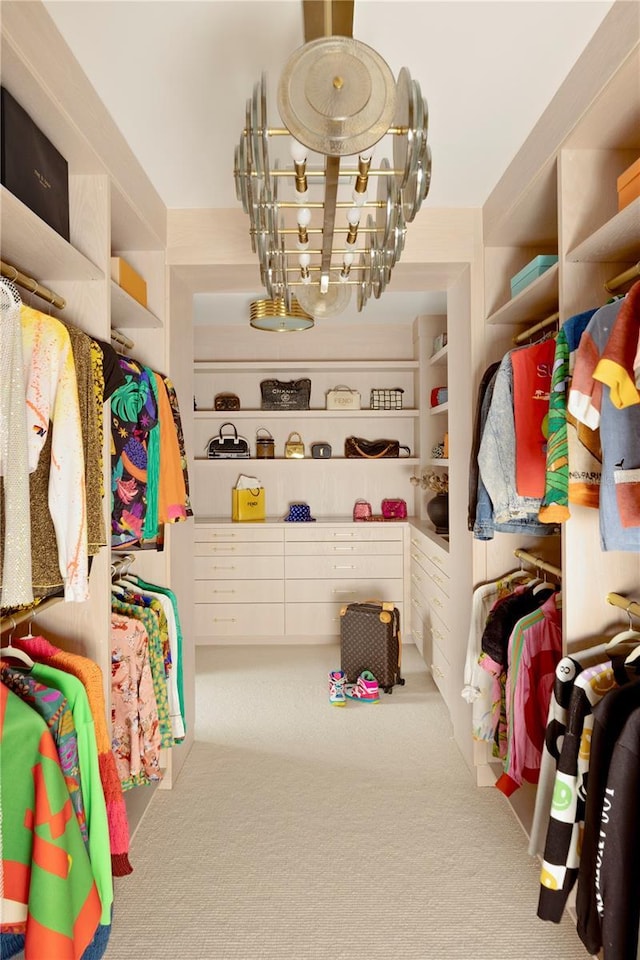 walk in closet with light colored carpet