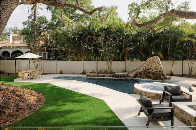 view of swimming pool with a patio area