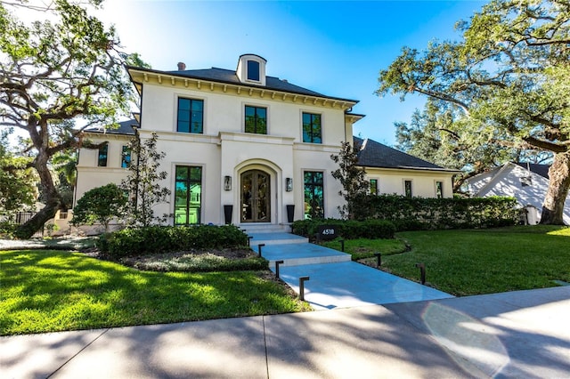 view of front of home with french doors and a front lawn