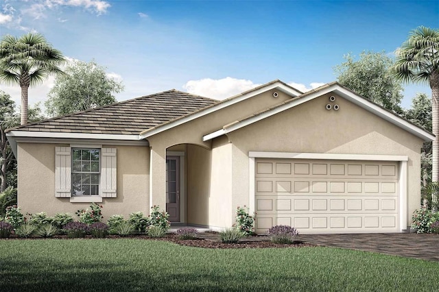 view of front of home with a front yard and a garage