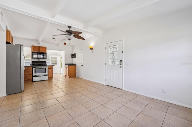 kitchen featuring stainless steel refrigerator, ceiling fan, vaulted ceiling with beams, stove, and light tile patterned flooring