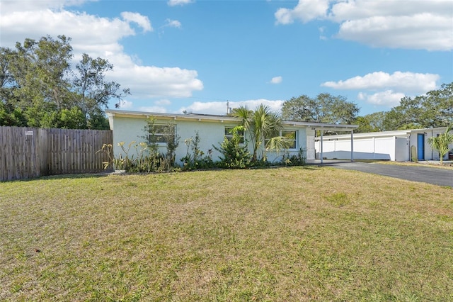 ranch-style home featuring a front yard and a carport