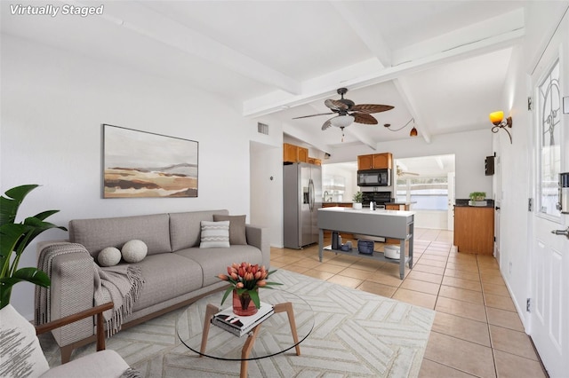 tiled living room featuring vaulted ceiling with beams and ceiling fan