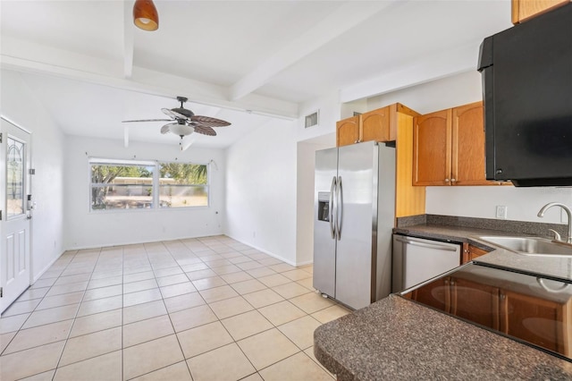 kitchen featuring lofted ceiling with beams, sink, ceiling fan, light tile patterned floors, and stainless steel appliances