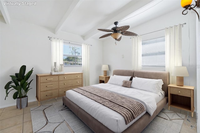 bedroom with beamed ceiling, ceiling fan, and light tile patterned floors