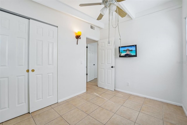 unfurnished bedroom with ceiling fan, a closet, and light tile patterned floors