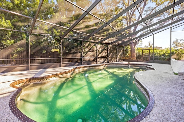 view of swimming pool with glass enclosure