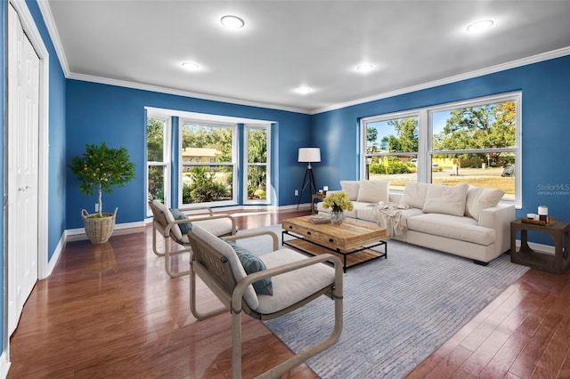 living room with crown molding, a wealth of natural light, and dark wood-type flooring