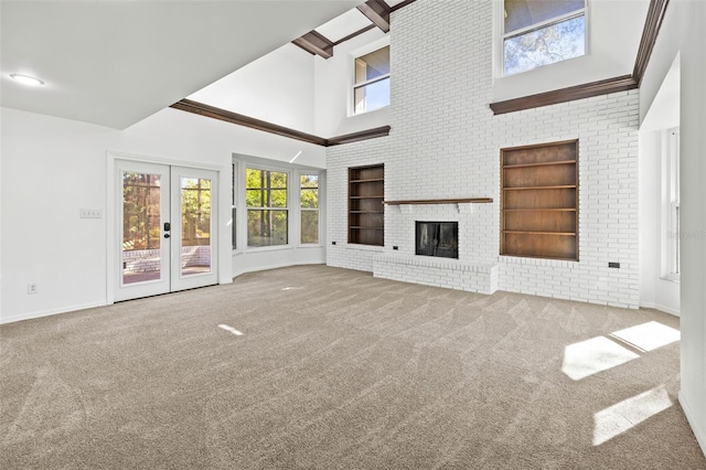 unfurnished living room with light colored carpet and french doors