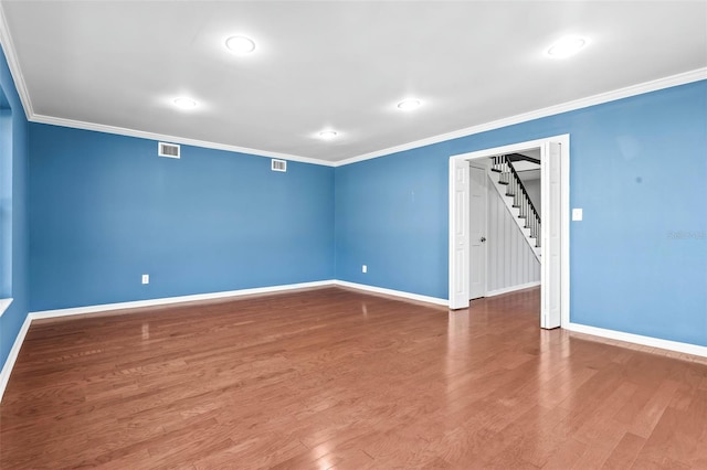 empty room with hardwood / wood-style flooring and ornamental molding