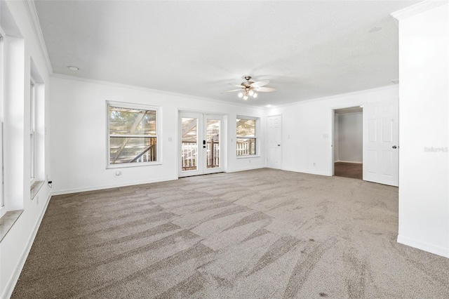 empty room with ceiling fan, carpet floors, and ornamental molding