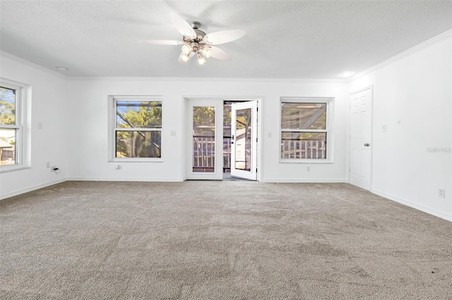 spare room with carpet flooring, ceiling fan, a textured ceiling, and ornamental molding