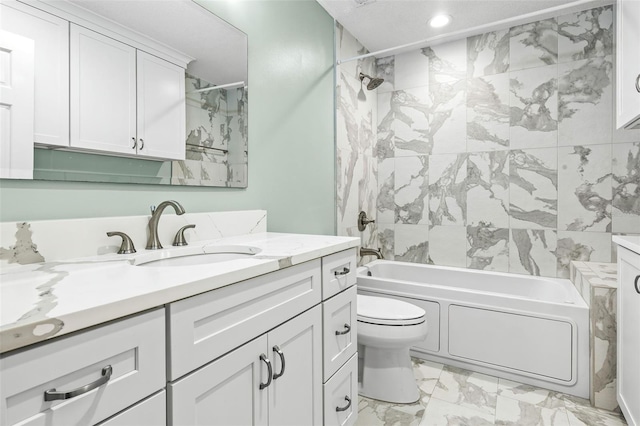 full bathroom featuring tiled shower / bath combo, toilet, and vanity