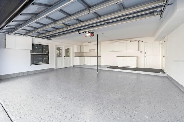 garage with french doors and a garage door opener