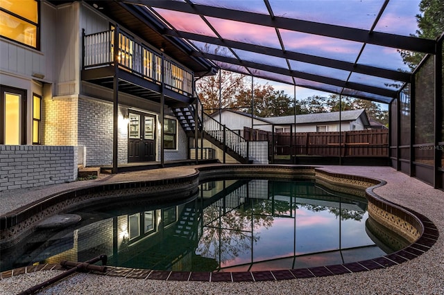 pool at dusk with glass enclosure