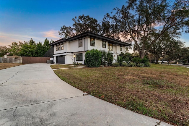 view of front facade with a garage and a lawn