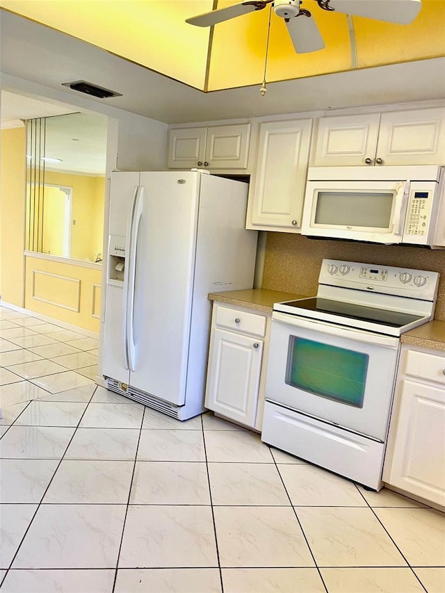 kitchen featuring light countertops, visible vents, a ceiling fan, white cabinetry, and white appliances