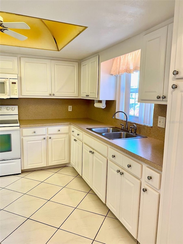 kitchen featuring ceiling fan, sink, light tile patterned floors, white appliances, and white cabinets