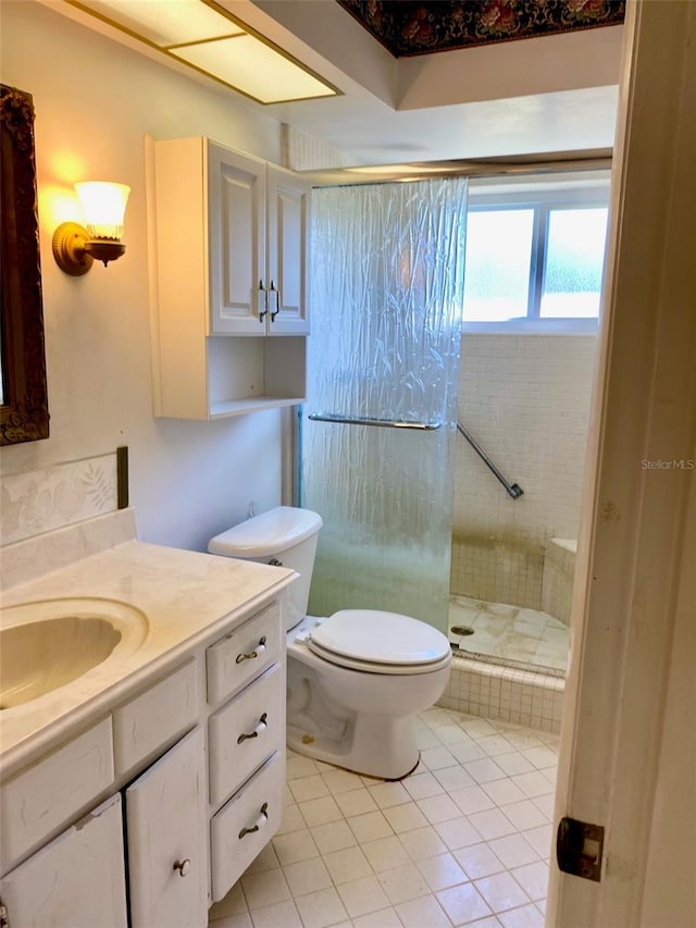 bathroom featuring tile patterned flooring, vanity, toilet, and an enclosed shower