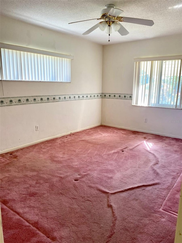 spare room featuring ceiling fan, carpet floors, and a textured ceiling